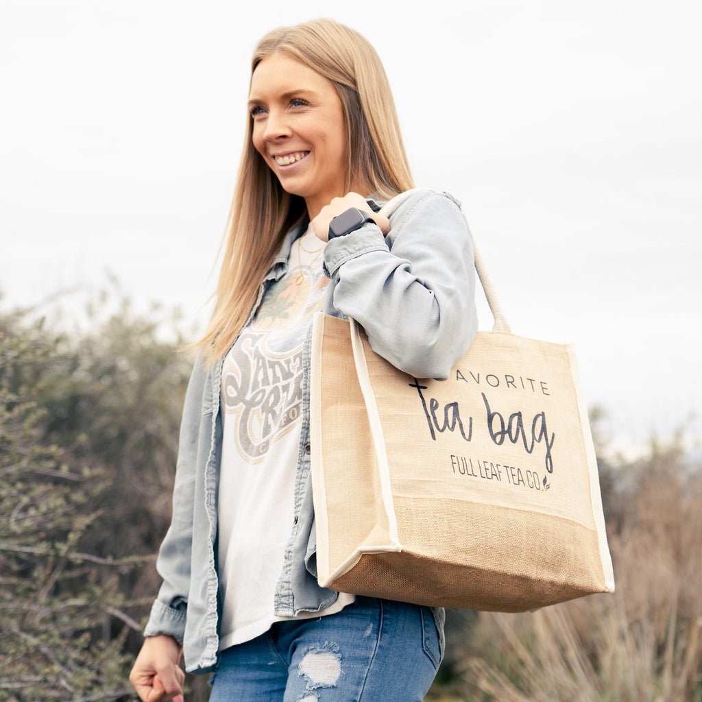 A Woman wearing the "My Favorite Tea Bag" Tote Bag over her shoulder.